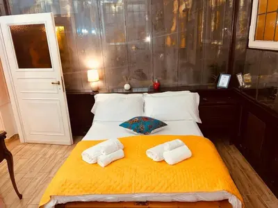 a bedroom with a bed with two towels on it at Aventino The Yellow Home in Rome