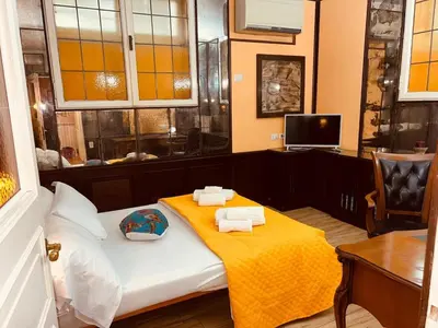 a room with a bed with a yellow blanket on it at Aventino The Yellow Home in Rome