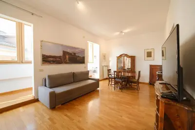 a living room with a couch and a television at Gian's Trevi BuddyRent in Rome
