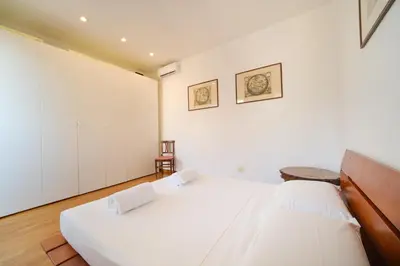 a bedroom with two beds and white walls at Gian's Trevi BuddyRent in Rome