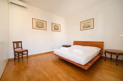 a bedroom with a bed and a table and a chair at Gian's Trevi BuddyRent in Rome