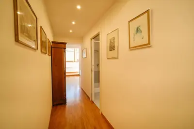 a hallway with paintings on the walls of a home at Gian's Trevi BuddyRent in Rome