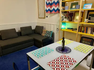 a living room with a couch and a table at Trastevere Hideaway in Rome