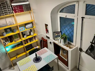 a living room with a table and a shelf at Trastevere Hideaway in Rome