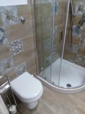 a bathroom with a toilet and a shower at White Sun in Rome