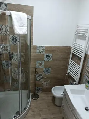 a bathroom with a shower and a toilet and a sink at White Sun in Rome