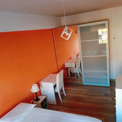 a bedroom with a bed and a desk and a table at White Sun in Rome