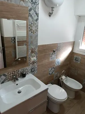 a bathroom with a white sink and a toilet at White Sun in Rome