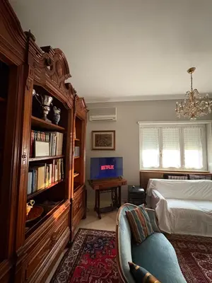 a bedroom with a bed and a book shelf at La Canfora in Rome
