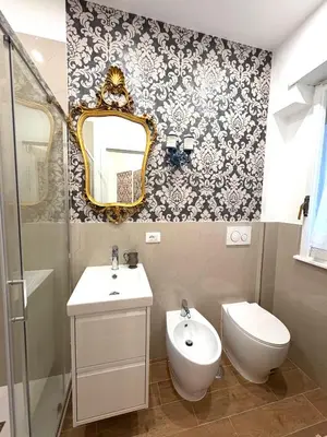 a bathroom with a toilet and a sink and a mirror at La Canfora in Rome