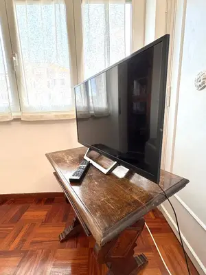 a large flat screen tv sitting on a table at La Canfora in Rome