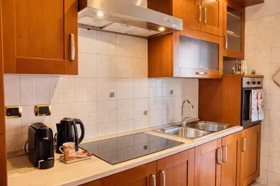 a kitchen with wooden cabinets and a sink at Pigneto84 in Rome