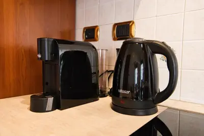 a black coffee maker sitting on top of a counter at Pigneto84 in Rome