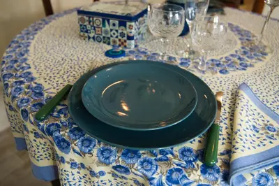 a black plate sitting on a blue and white table at Pigneto84 in Rome