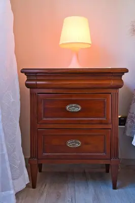 a wooden dresser with a lamp on top of it at Pigneto84 in Rome