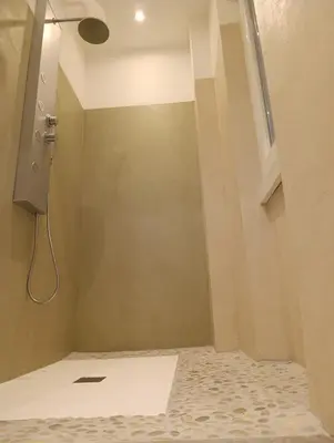 a bathroom with a shower with a window and a tile floor at Rome Tiburtina Terrace Inn - casa vacanze in Rome