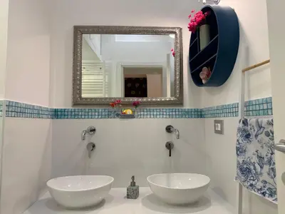 a bathroom with two sinks and a mirror at Midorigami Jacuzzi suite Spanish Steps apt in Rome