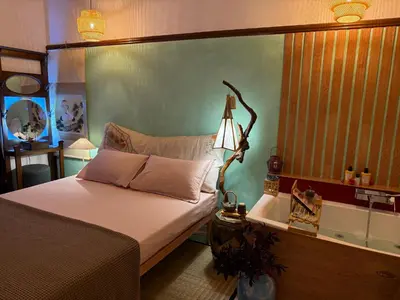 a bedroom with a bed with a lamp on it at Midorigami Jacuzzi suite Spanish Steps apt in Rome