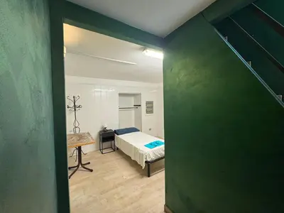 a bedroom with a bed and a table in a room at Alloggio turistico di Filomena Landi in Rome