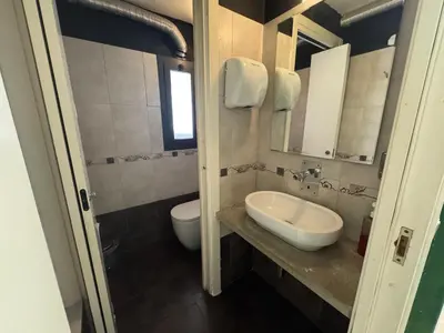 a bathroom with a sink and a toilet and a mirror at Alloggio turistico di Filomena Landi in Rome