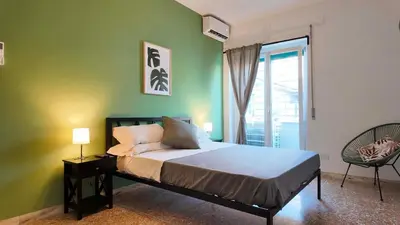 a bedroom with a bed with a green wall at Vatican St Peter Apartment in Rome