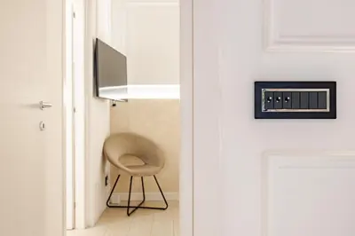 a chair sitting in a hallway next to a door at Boutique Apartment Steps from Colosseum in Rome