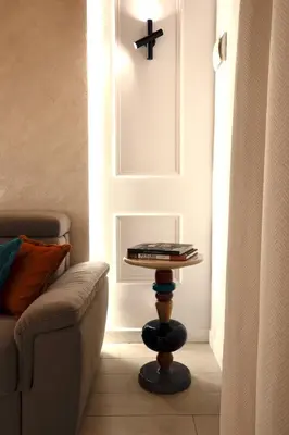 a table with books on it next to a couch at Boutique Apartment Steps from Colosseum in Rome