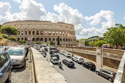 a traffic jam in front of the coliseum at Boutique Apartment Steps from Colosseum in Rome