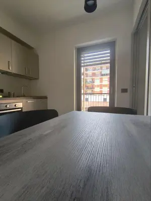 a kitchen with a large wooden table in a room at Romanello case e appartamenti vacanza in Rome