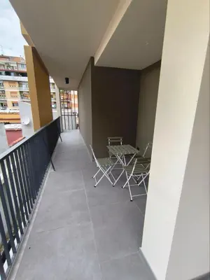 a balcony with tables and chairs on a building at Romanello case e appartamenti vacanza in Rome