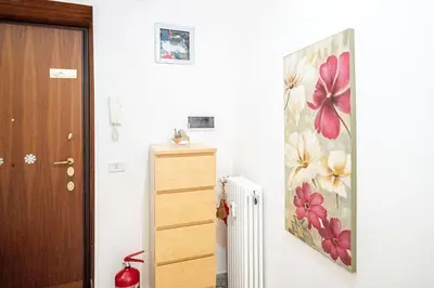 a room with a radiator and a painting on the wall at Rome Sweet Home I Elegance and Authenticity in Rome