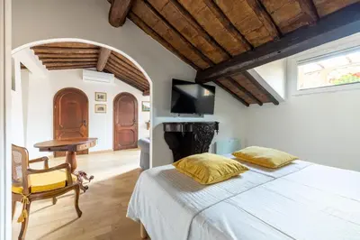 a bedroom with a bed and a desk and a television at Attico con terrazza privata silenzioso casa Mem in Rome