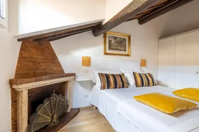 a bedroom with a bed and a fireplace at Attico con terrazza privata silenzioso casa Mem in Rome