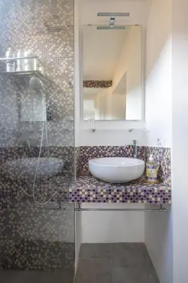 a bathroom with a sink and a mirror and a shower at Attico con terrazza privata silenzioso casa Mem in Rome