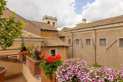 a balcony with flowers in boxes on a building at Attico con terrazza privata silenzioso casa Mem in Rome