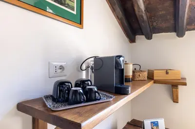 a counter with a coffee maker and a coffeemaker at Attico con terrazza privata silenzioso casa Mem in Rome