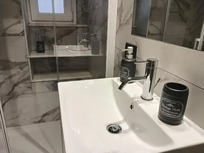 a bathroom with a sink with a soap dispenser on it at Feffo's home - Casa per 4 persone in Rome