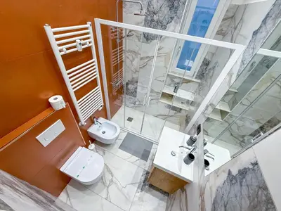 a bathroom with two toilets and a sink and a shower at Feffo's home - Casa per 4 persone in Rome