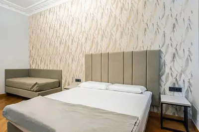 a bedroom with a bed and a chair at Gracchi Vatican View in Rome