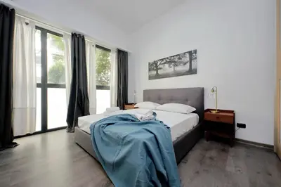 a bedroom with a bed with a blue blanket on it at La Dolce Vita - Your perfect base to explore Rome in Rome