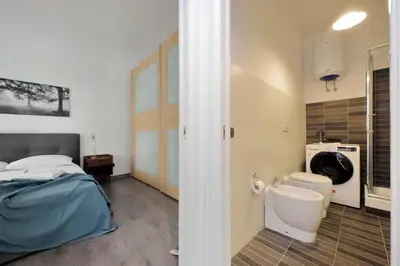 a bedroom with a bed and a washing machine at La Dolce Vita - Your perfect base to explore Rome in Rome