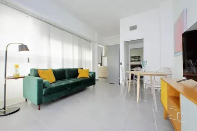 a living room with a green couch and a table at La Dolce Vita - Your perfect base to explore Rome in Rome