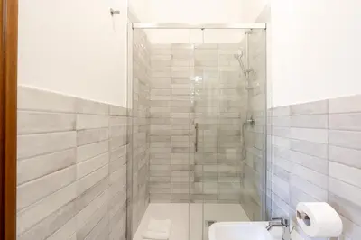 a bathroom with a shower and a toilet and a sink at Guest House Rome - Pigneto in Rome