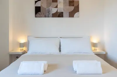 a bedroom with a white bed with two white pillows at Guest House Rome - Pigneto in Rome