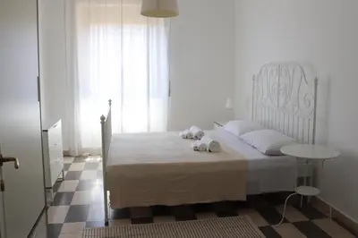 a bedroom with a bed with two stuffed animals on it at Dimora Trasteverina Holiday Home in Rome