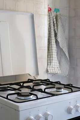 a white stove top oven sitting in a kitchen at Dimora Trasteverina Holiday Home in Rome
