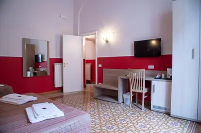 a room with a table and a desk with a television at Domus Napoleone in Rome