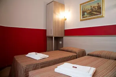 a room with two beds with towels on them at Domus Napoleone in Rome
