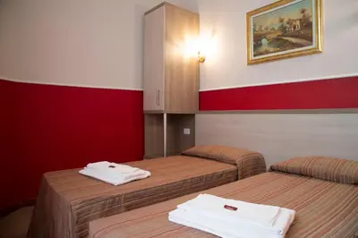 a room with two beds with white towels on them at Domus Napoleone in Rome