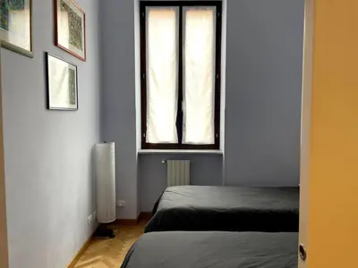 a room with two beds and a window at Civico43 in Rome